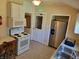 Kitchen with white appliances, wood cabinets, and a stainless steel refrigerator at 3310 N Kenwood Ave, Indianapolis, IN 46208