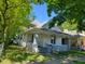 White bungalow with gray brick base and porch at 3310 N Kenwood Ave, Indianapolis, IN 46208