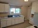 Bright kitchen featuring white cabinets, double sink, and ample counter space at 3310 N Kenwood Ave, Indianapolis, IN 46208
