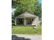 Quaint house with a covered porch and a large front yard at 3912 Terrace Ave, Indianapolis, IN 46203