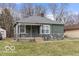 Charming ranch home with stone accents and mature trees at 3755 N Hawthorne Ln, Indianapolis, IN 46218