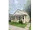 Cute yellow house with front porch and small yard at 212 Hancock Ave, Indianapolis, IN 46222