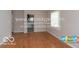 Hardwood floors, neutral walls, and view of kitchen at 3521 N Riley Ave, Indianapolis, IN 46218