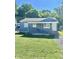 Ranch style home with blue siding, lawn, and small porch at 3521 N Riley Ave, Indianapolis, IN 46218