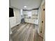 Modern kitchen with white cabinets and laminate flooring at 20 N Pershing Ave, Indianapolis, IN 46222