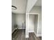 Functional laundry area with vinyl flooring and built-in shelving at 20 N Pershing Ave, Indianapolis, IN 46222