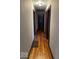 Long hallway with hardwood floors and doors leading to other rooms at 57 N Tremont St, Indianapolis, IN 46222