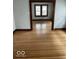 Living room with hardwood floors and view into another room at 57 N Tremont St, Indianapolis, IN 46222