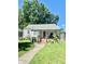 Ranch home with gray siding, red door, and porch at 1618 N Linwood Ave, Indianapolis, IN 46218