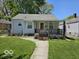 House with gray siding, small porch, and green lawn at 1618 N Linwood Ave, Indianapolis, IN 46218