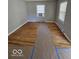 Bright living room featuring hardwood floors and two windows at 1618 N Linwood Ave, Indianapolis, IN 46218