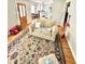 Living room with hardwood floors, beige sofa, and view of kitchen at 1618 N Linwood Ave, Indianapolis, IN 46218