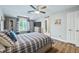 Spacious bedroom with plaid bedding, large window, and built-in storage at 4023 Cedar Hills N Dr, Greenwood, IN 46143