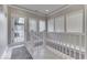 Bright landing with tile flooring, white railing, and access to backyard patio at 4023 Cedar Hills N Dr, Greenwood, IN 46143