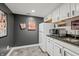 Basement kitchenette with microwave, refrigerator, and granite countertop at 4023 Cedar Hills N Dr, Greenwood, IN 46143