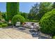Elegant outdoor furniture set on a large patio with lush landscaping providing shade and relaxation at 4023 Cedar Hills N Dr, Greenwood, IN 46143