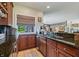 Wet bar with granite countertops and dark wood cabinets at 4023 Cedar Hills N Dr, Greenwood, IN 46143