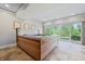 Spacious basement hot tub with large windows overlooking the backyard at 4023 Cedar Hills N Dr, Greenwood, IN 46143