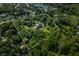 Aerial view of a large home on a spacious lot with mature trees and a tranquil lake nearby at 4023 Cedar Hills N Dr, Greenwood, IN 46143