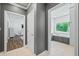 Hallway with access to bedroom and bathroom, featuring gray walls and tile floors at 4023 Cedar Hills N Dr, Greenwood, IN 46143