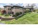 Brick home with extensive landscaping and stone retaining wall at 4023 Cedar Hills N Dr, Greenwood, IN 46143