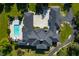 Top-down view of a large estate with a pool and ample parking. The home features a complex roofline at 4023 Cedar Hills N Dr, Greenwood, IN 46143
