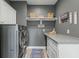 Bright laundry room with modern washer and dryer, ample counter space, and white cabinets at 4023 Cedar Hills N Dr, Greenwood, IN 46143
