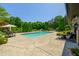 Expansive pool and patio area with lush landscaping and comfortable seating for outdoor enjoyment at 4023 Cedar Hills N Dr, Greenwood, IN 46143