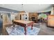 Game room with pool table, fireplace, and access to patio at 4023 Cedar Hills N Dr, Greenwood, IN 46143
