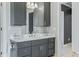 Modern bathroom with dark gray vanity and marble countertop at 4023 Cedar Hills N Dr, Greenwood, IN 46143
