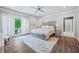 Bright bedroom with king-size bed, hardwood floors, and patio access at 4023 Cedar Hills N Dr, Greenwood, IN 46143