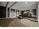 Home theater with tiered seating and movie memorabilia decor at 4023 Cedar Hills N Dr, Greenwood, IN 46143