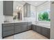 Spa-like bathroom with soaking tub, double vanity, and gray cabinets at 4023 Cedar Hills N Dr, Greenwood, IN 46143