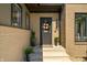 Charming front entrance with dark gray door and potted plants at 4023 Cedar Hills N Dr, Greenwood, IN 46143