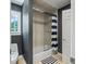 Bathroom with bathtub, shower, and blue and white striped shower curtain at 4023 Cedar Hills N Dr, Greenwood, IN 46143