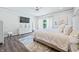Spacious bedroom with king-size bed, hardwood floors, and access to patio at 4023 Cedar Hills N Dr, Greenwood, IN 46143