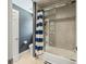 Bathroom with shower, toilet, and blue and white striped shower curtain at 4023 Cedar Hills N Dr, Greenwood, IN 46143