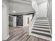 Basement hallway with stairs, hardwood floors and doors to other rooms at 4023 Cedar Hills N Dr, Greenwood, IN 46143