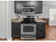 Stainless steel appliances and dark wood cabinets in the kitchen at 917 Balto Dr, Shelbyville, IN 46176