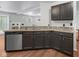 Modern kitchen with dark cabinets, stainless steel appliances, and granite countertops at 917 Balto Dr, Shelbyville, IN 46176
