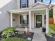 Inviting front porch with a bench and potted plants at 917 Balto Dr, Shelbyville, IN 46176
