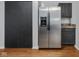 Stainless steel refrigerator in the kitchen with dark cabinets at 917 Balto Dr, Shelbyville, IN 46176