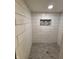 Updated shower with white subway tile and pebble floor at 1231 E 88Th St, Indianapolis, IN 46240