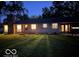 Well-lit ranch house exterior, showcasing a stone facade and neat lawn at 1231 E 88Th St, Indianapolis, IN 46240