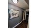 Bright hallway with dark hardwood floors and framed art at 1231 E 88Th St, Indianapolis, IN 46240
