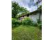 Side view of the house showing a large deck and landscaping at 1231 E 88Th St, Indianapolis, IN 46240