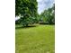 Large front yard with mature trees and a long driveway at 1231 E 88Th St, Indianapolis, IN 46240