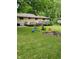 Spacious backyard with deck, fire pit, and plenty of grass at 1231 E 88Th St, Indianapolis, IN 46240