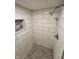 Updated shower with white subway tile and pebble floor at 1231 E 88Th St, Indianapolis, IN 46240