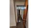Long hallway with dark hardwood floors and access to rooms at 1231 E 88Th St, Indianapolis, IN 46240